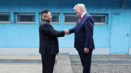 FILE PHOTO: US President Donald Trump shakes hands with North Korean leader Kim Jong Un as they meet at the demilitarized zone.