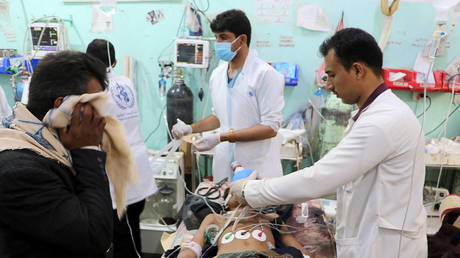 FILE PHOTO. A man injured by an air strike on a market in Yemen's Saada province receives medical attention, July 29, 2019