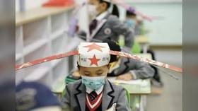 Thinking caps on: Chinese school kids return to classroom with the help of ‘social distancing hats’ (PHOTOS)