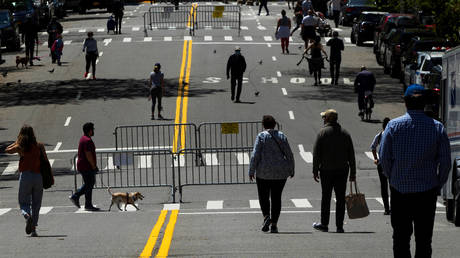FILE PHOTO: People walk along a street in New York, US, on MAy 2, 2020.