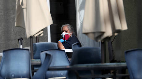 A woman on the patio of the Gateway Care and Rehabilitation Center in Hayward, California