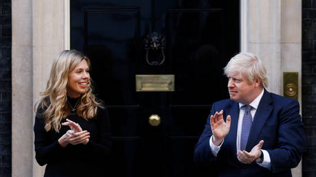 Britain's Prime Minister Boris Johnson and partner Carrie Symonds applaud outside 10 Downing Street in support of the NHS, London, May 14, 2020.