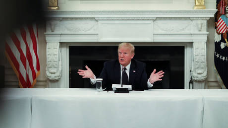 Donald Trump talks about taking daily doses of hydroxychloroquine pills in the State Dining Room at the White House in Washington