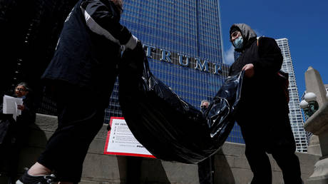 FILE PHOTO: Protesters carry homemade body bags in front of the Trump International Hotel and Tower in Chicago, Illinois