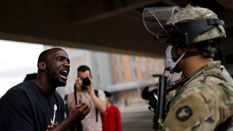 A man confronts a National Guard soldier in Minneapolis, Minnesota as journalists take photos, May 29, 2020.