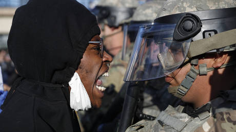 A protester yells at a member of the Minnesota National Guard on Friday. © AP Photo/John Minchillo