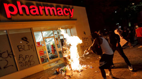 Rioters set fire to items looted from a pharmacy during the unrest following the death of George Floyd and US-wide protests. Raleigh, North Carolina, May 30, 2020.