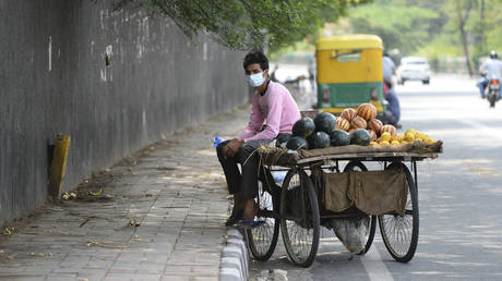 A fruit vendor waits for costumers in New Delhi, India