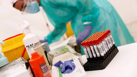 FILE PHOTO: A health worker stands by test tubes with blood at a temporary Covid-19 testing station in Torrejon de Ardoz, Spain, on May 29, 2020.