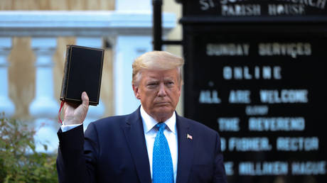 U.S. President Donald Trump holds up a Bible as he stands in front of St. John's Episcopal Church across from the White House. June 1, © Reuters / Tom Brenner