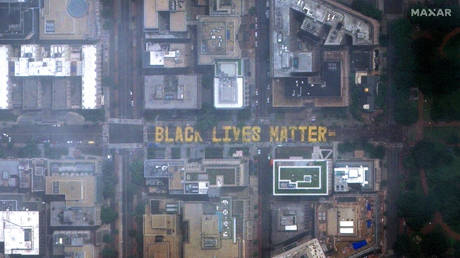 People walk along 16th Street NW with many gathering on and near the new "Black Lives Matter" lettering painted on the street in Washington, DC, on June 6, © Reuters / Maxar Technologies