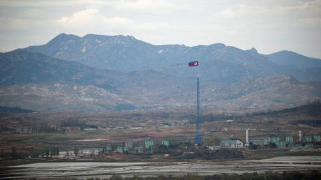 FILE PHOTO: A North Korean flag flutters on top of a 160-metre tower in the village of Gijungdong near the demilitarised zone separating the two Koreas