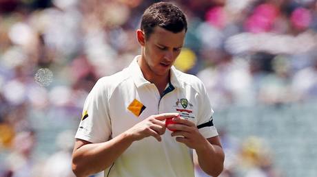 Australia's Josh Hazlewood shines the ball