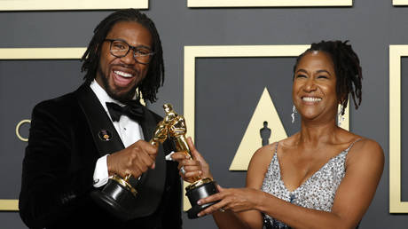 Matthew A. Cherry and Karen Rupert Toliver pose with the Oscar for Best Animated Short Film for “Hair Love,” at the 92nd Academy Awards in Hollywood, February 9, 2020.