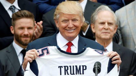 FILE PHOTO: US President Donald Trump holds up a New England Patriots jersey during an event honoring the Super Bowl champion team at the White House in Washington, US, April 19, 2017