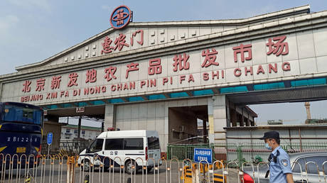 A police officer wearing a face mask is seen outside an entrance of the Xinfadi wholesale market in Beijing, China, June 13, 2020