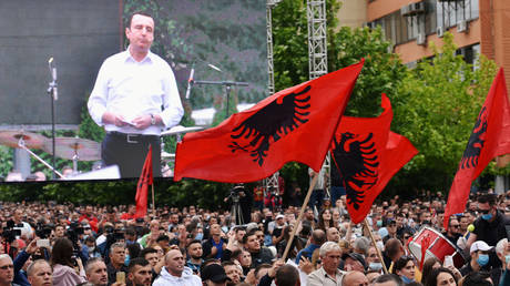 Ousted 'PM' of Kosovo Albin Kurti speaks to supporters who waved Albanian flags at a protest against the new government in Pristina, June 12, 2020.