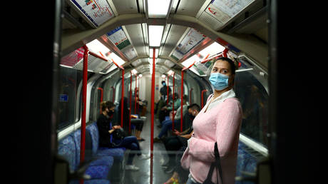 FILE PHOTO: A passenger wearing a face mask travels on the London tube, amid the spread of the coronavirus disease © REUTERS/Hannah McKay/File Photo