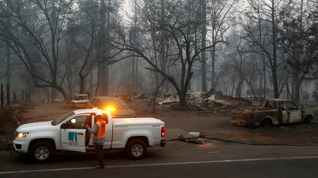 Employees of Pacific Gas & Electric (PG&E) work in the aftermath of the Camp Fire in Paradise, California, November 14, 2018.