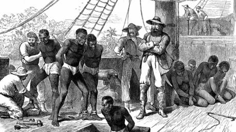 Captives being brought on board a slave ship on the West Coast of Africa. Wood engraving c. 1880 © Global Look Press