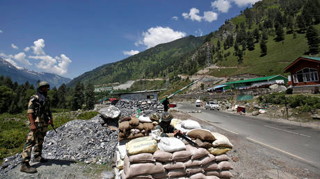 India's Border Security Force (BSF) soldiers stand guard at a checkpoint along a highway leading to Ladakh, at Gagangeer in Kashmir's Ganderbal district