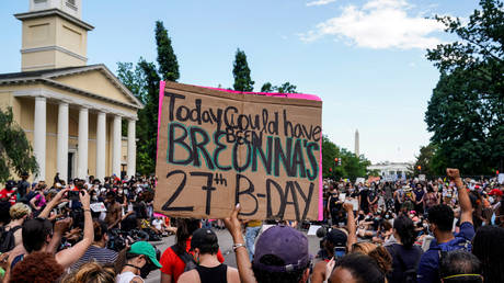 A demonstrator holds up a sign for Breonna Taylor as protests against the death in Minneapolis police custody of George Floyd, continue in Washington, US, June 5, 2020
