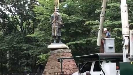 Workers remove the statue of Christopher Columbus in New Haven, Connecticut, June 24, 2020.