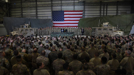 Afghanistan's President Ashraf Ghani and US President Donald Trump speak to US soldiers at Bagram Air Field, Afghanistan. November 2019. © Olivier Douliery / AFP
