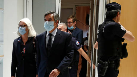 Former French prime minister Francois Fillon and his wife Penelope leave following the verdict in their trial over a fake jobs scandal at the courthouse in Paris, France, on June 29, 2020.