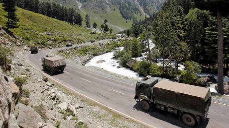Indian army trucks move along a highway leading to Ladakh, at Gagangeer in Kashmir's Ganderbal district June 17, 2020