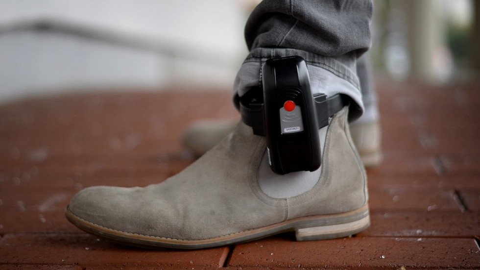 Ankle monitors, house arrest, & armed guards: Covid-19 enforcement measures ramp up even as lockdowns wind down