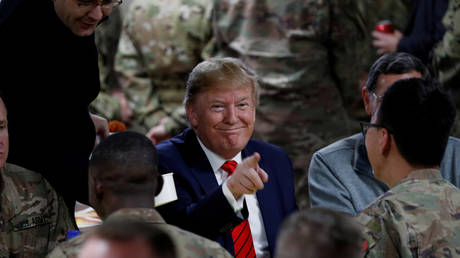 FILE PHOTO: US President Donald Trump eats dinner with US troops at a Thanksgiving dinner event during a surprise visit at Bagram Air Base in Afghanistan, November 28, 2019.