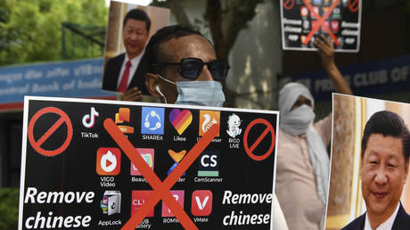 Members of the Working Journalist of India (WJI) hold placards urging citizens to remove Chinese apps in New Delhi on June 30, 2020