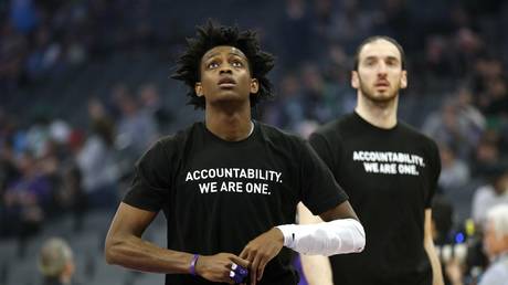 FILE PHOTO: Sacramento Kings guard De'Aaron Fox stands on the court before the start of a game against the Boston Celtics, at which players from both teams wore shirts during warm-ups in honor of a California man killed by police.