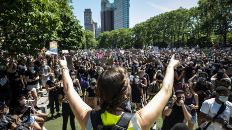 One of the Unite NY 2020 organizers Elizabeth Vargas holds up her hands to the thousands of protesters gathered on the lawn in Cadman Plaza, Brooklyn for a peaceful protest and march to support Black Lives Matter and protest against police brutality across the Brooklyn Bridge on June 19, 2020, USA