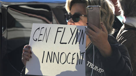 A Trump supporter holds a sign during a court appearance of former national security adviser Michael Flynn in Washington, DC, December 18, 2018.