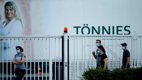 FILE PHOTO: Employees are seen outside the main Toennies meat factory in Rheda-Wiedenbrueck, Germany, on June 20, 2020.