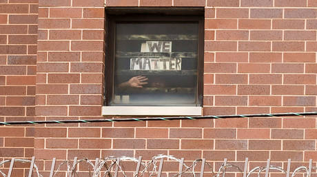 An inmate holds a sign to his cell window reading "We Matter" as Black Lives Matter supporters hold a protest against racial inequality on Father's Day outside Cook County Jail in Chicago, Illinois, U.S. June 21, 2020