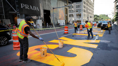 FILE PHOTO: Workers re-paint a portion of a Black Lives Matter mural that was vandalized with paint outside Trump Tower in New York City, July 13, 2020.