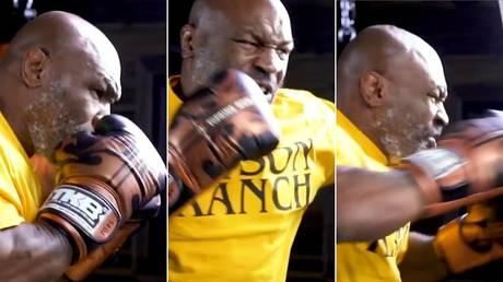 Looking scary: Mike Tyson smashes the pads