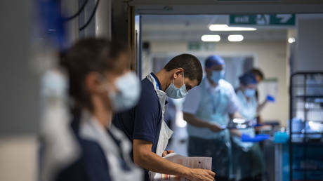 A Rehab Support worker checks on patient notes as the first patients are admitted to the NHS Seacole Centre at Headley Court, Surrey, a disused military hospital, which has been converted during the coronavirus pandemic, May 28, 2020