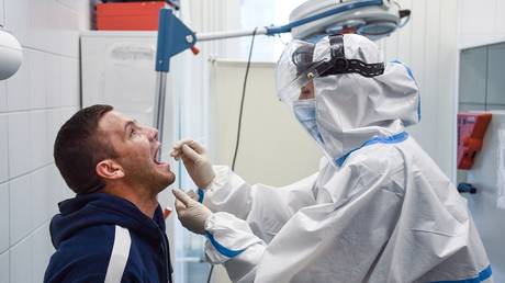 FILE PHOTO. A medical worker takes samples for a Covid-19 test at Moscow’s Sheremetyevo International Airport. ©Sputnik / Yevgeny Odinokov