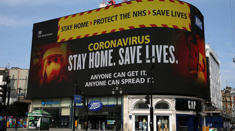 A NHS signage about coronavirus advice people to "Stay home. Save lives" is displayed on the advertising boards at Piccadilly Circus in London United Kingdom on April 16, 2020