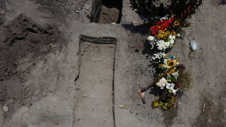 FILE PHOTO: Digging tools are seen next to a grave