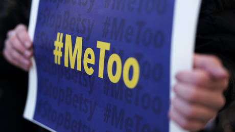 FILE PHOTO: An activist holds a #MeToo sign during a news conference on a Title IX lawsuit outside the Department of Education January 25, 2018 in Washington