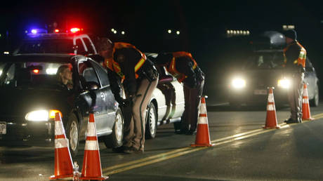 FILE PHOTO: Jefferson County Sheriff Department officers ask drivers if they have been drinking while smelling for alcohol at checkpoint in Golden, Colorado April 12, 2008.
