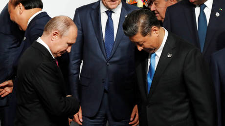 FILE PHOTO. Russian President Vladimir Putin and Chinese President Xi Jinping prepare for family photo session at the G20 leaders summit in Osaka, Japan, June 28, 2019.