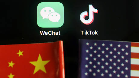 The messenger app WeChat and short-video app TikTok are seen near China and U.S. flags August 7, 2020.