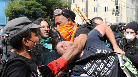 CHAZ/CHOP protesters remove man for bothering them, June 13, 2020 © REUTERS/Goran Tomasevic