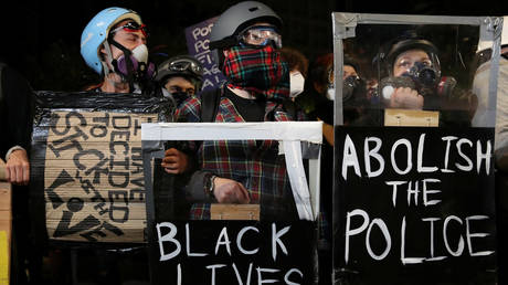 FILE PHOTO: Demonstrators attend a protest against police brutality in Portland, Oregon.